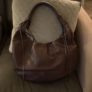 Juicy Couture leather hobo handbag with fringe and chains in the size.